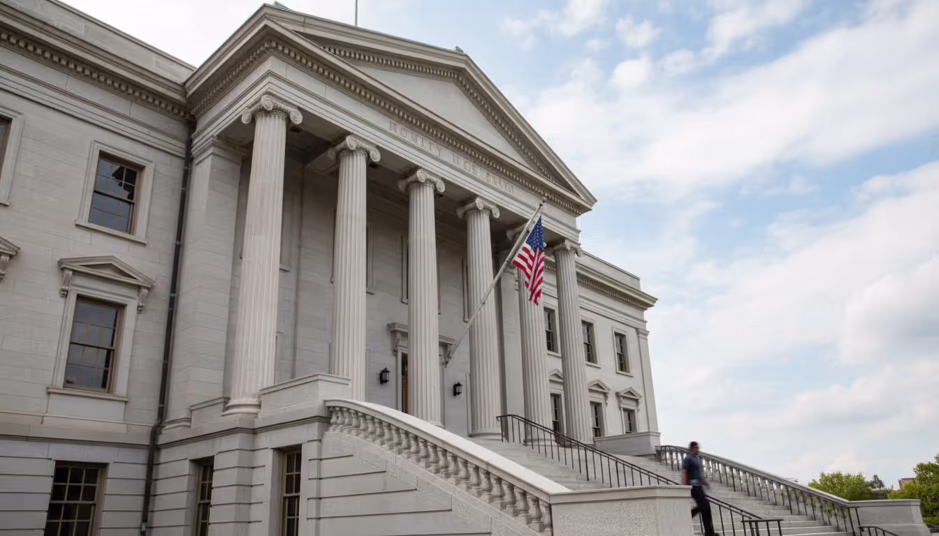 American county courthouse building exterior with columns and steps with a person walking up the stairs
