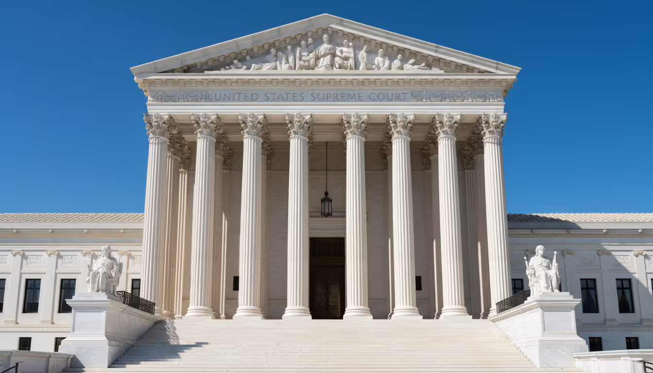 Front facade of the United States Supreme Court building with columns and steps on a clear day